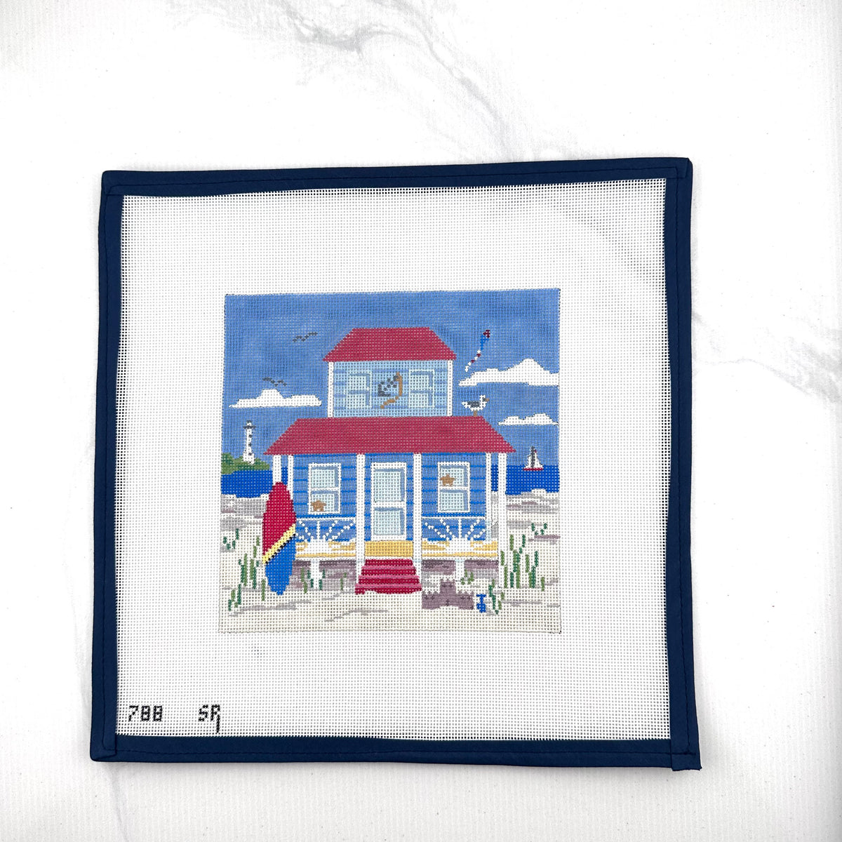 susan roberts blue beach cottage needlepoint canvas, 18 mesh, square 6.25" x 6.25" lying flat on white background