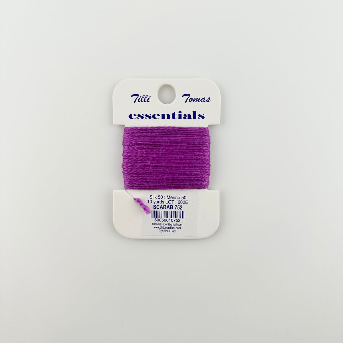 Tilli Tomas Essentials needlepoint thread, in purple color scarab 752. 50% silk, 50% merino wool, 10 yards wound on a white cardboard card.