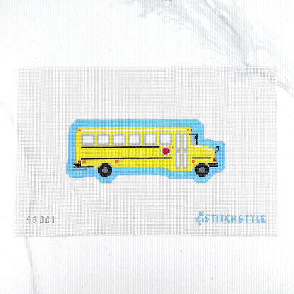 A 18 mesh needlepoint canvas featuring a yellow school bus with black wheels and a blue shadow, on a white background with the Stitchstyle logo in the bottom right corner.