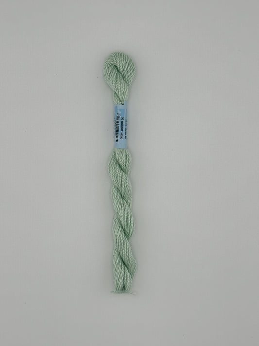 30 yard skein of essentials needlepoint thread in Aloe S685 green, with blue label lying flat on white background