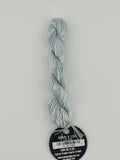14 yard skein Planet Earth Silk 4 Ply needlepoint thread, in angel v 1328, with round black and white label lying flat on white background.