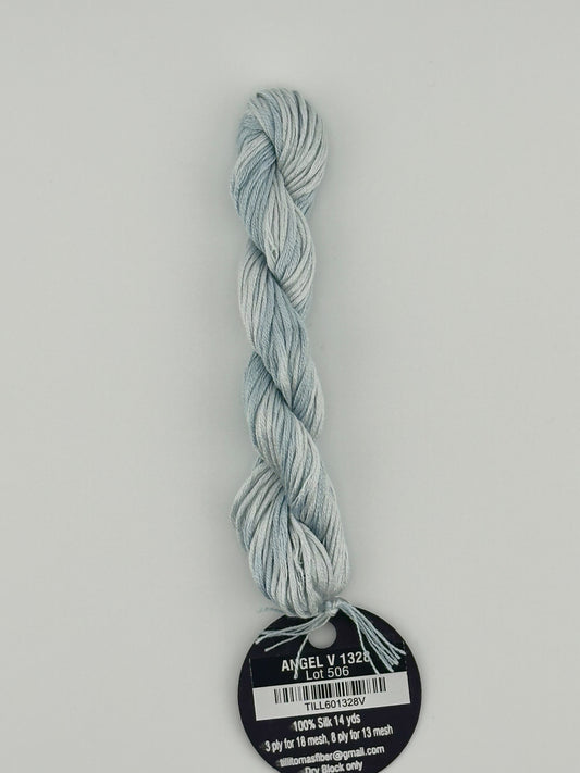 14 yard skein Planet Earth Silk 4 Ply needlepoint thread, in angel v 1328, with round black and white label lying flat on white background.