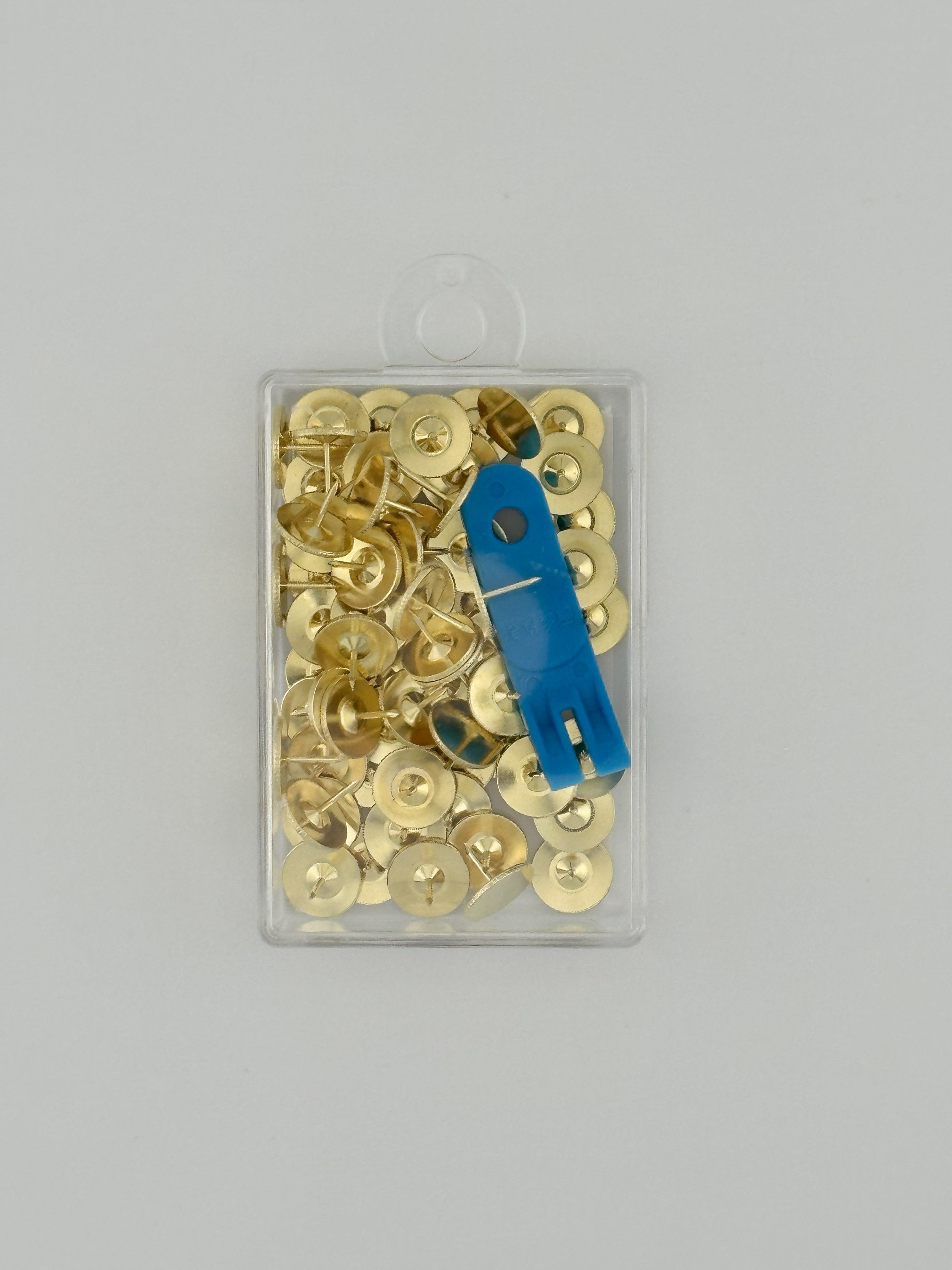 Clover brand brass thumb tacks with remover in clear plastic case on white background