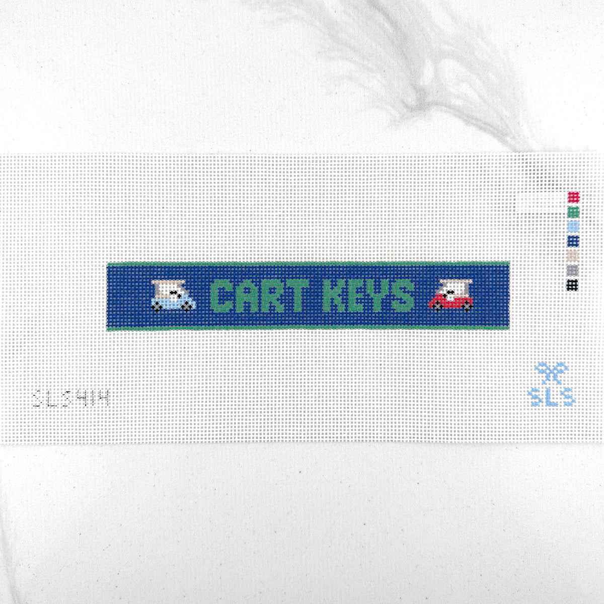 A needlepoint key fob canvas featuring a blue and green sign with the text 'CART KEYS' in green on 14 mesh lying flat on white background.