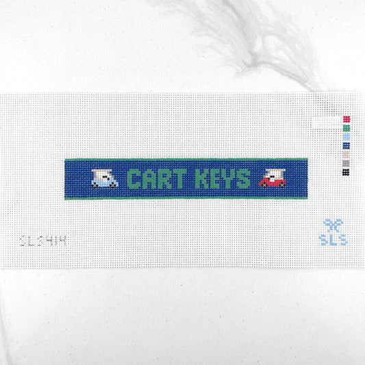 A needlepoint key fob canvas featuring a blue and green sign with the text 'CART KEYS' in green on 14 mesh lying flat on white background.