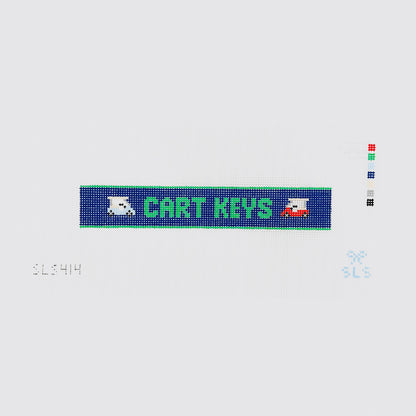 A needlepoint key fob canvas featuring a blue and green sign with the text 'CART KEYS' in green on 14 mesh lying flat on white background.