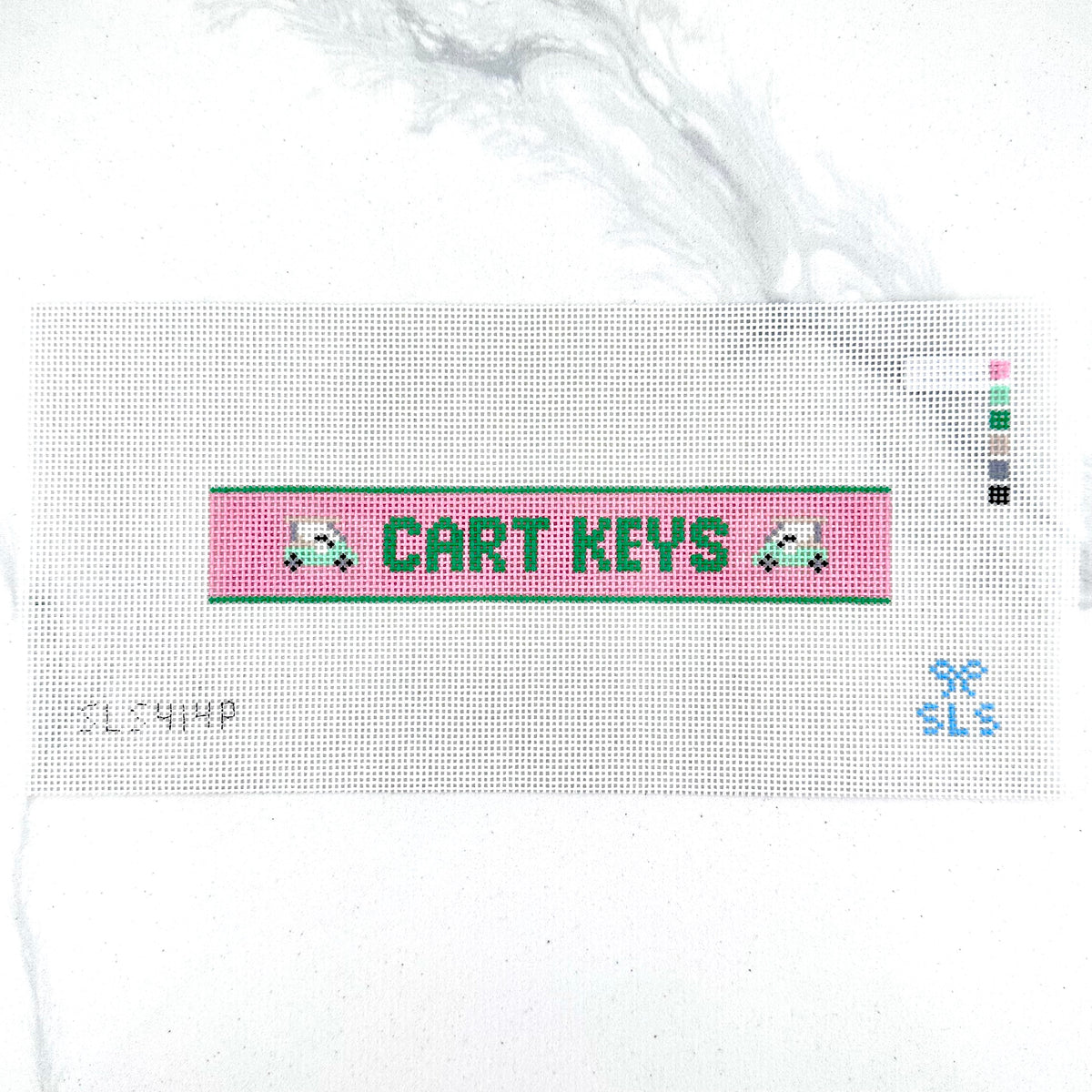 A needlepoint key fob canvas featuring a pink and green sign with the text 'CART KEYS' in green on 14 mesh lying flat on white background.