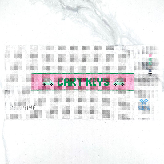 A needlepoint key fob canvas featuring a pink and green sign with the text 'CART KEYS' in green on 14 mesh lying flat on white background.