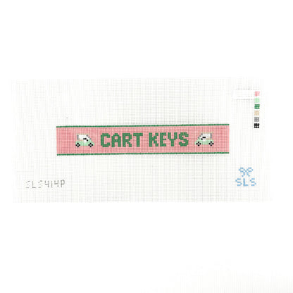 A needlepoint key fob canvas featuring a pink and green sign with the text 'CART KEYS' in green on 14 mesh lying flat on white background.