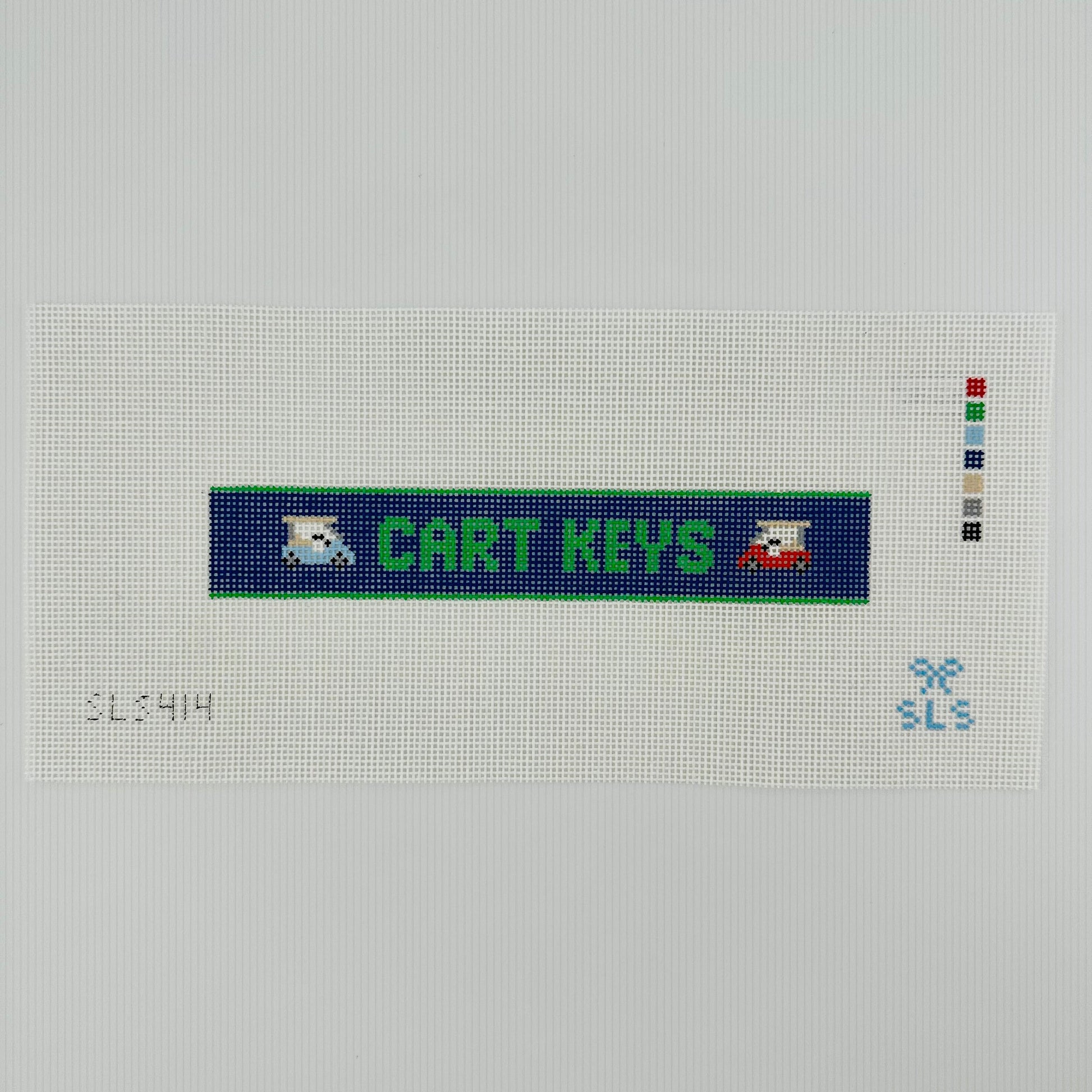 A needlepoint key fob canvas featuring a blue and green sign with the text 'CART KEYS' in green on 14 mesh lying flat on white background.