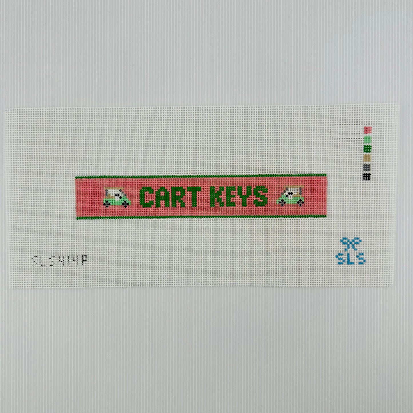 A needlepoint key fob canvas featuring a pink and green sign with the text 'CART KEYS' in green on 14 mesh lying flat on white background.