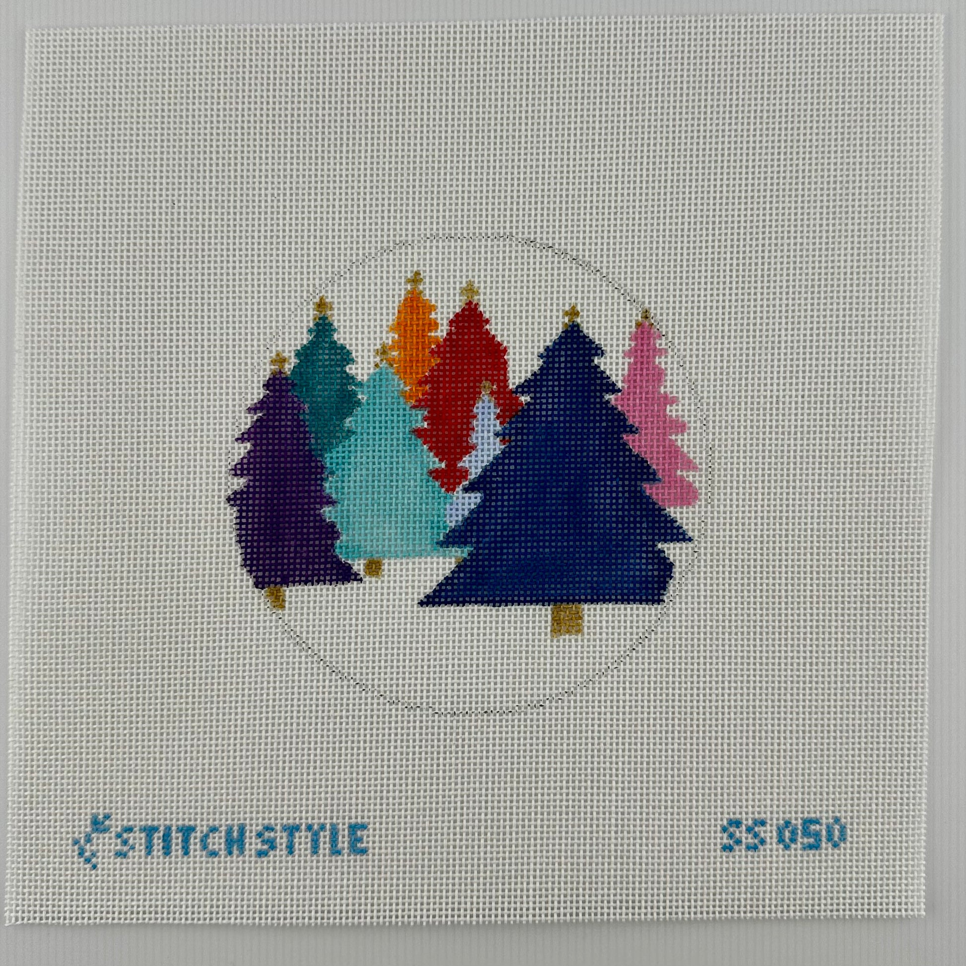 18 mesh needlepoint canvas featuring a circular design of colorful Christmas trees in purple, teal, light blue, red, orange, and pink on a white mesh background. The brand name 'STITCHSTYLE' is stitched in blue at the bottom left, and the number '35050' is stitched at the bottom right.