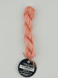 14 yard skein Planet Earth Silk 4 Ply needlepoint thread, in coral v 1324, with round black and white label lying flat on white background.