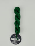 14 yard skein Planet Earth Silk 4 Ply needlepoint thread, in Gecko V 1333 green with round black and white label lying flat on white background.