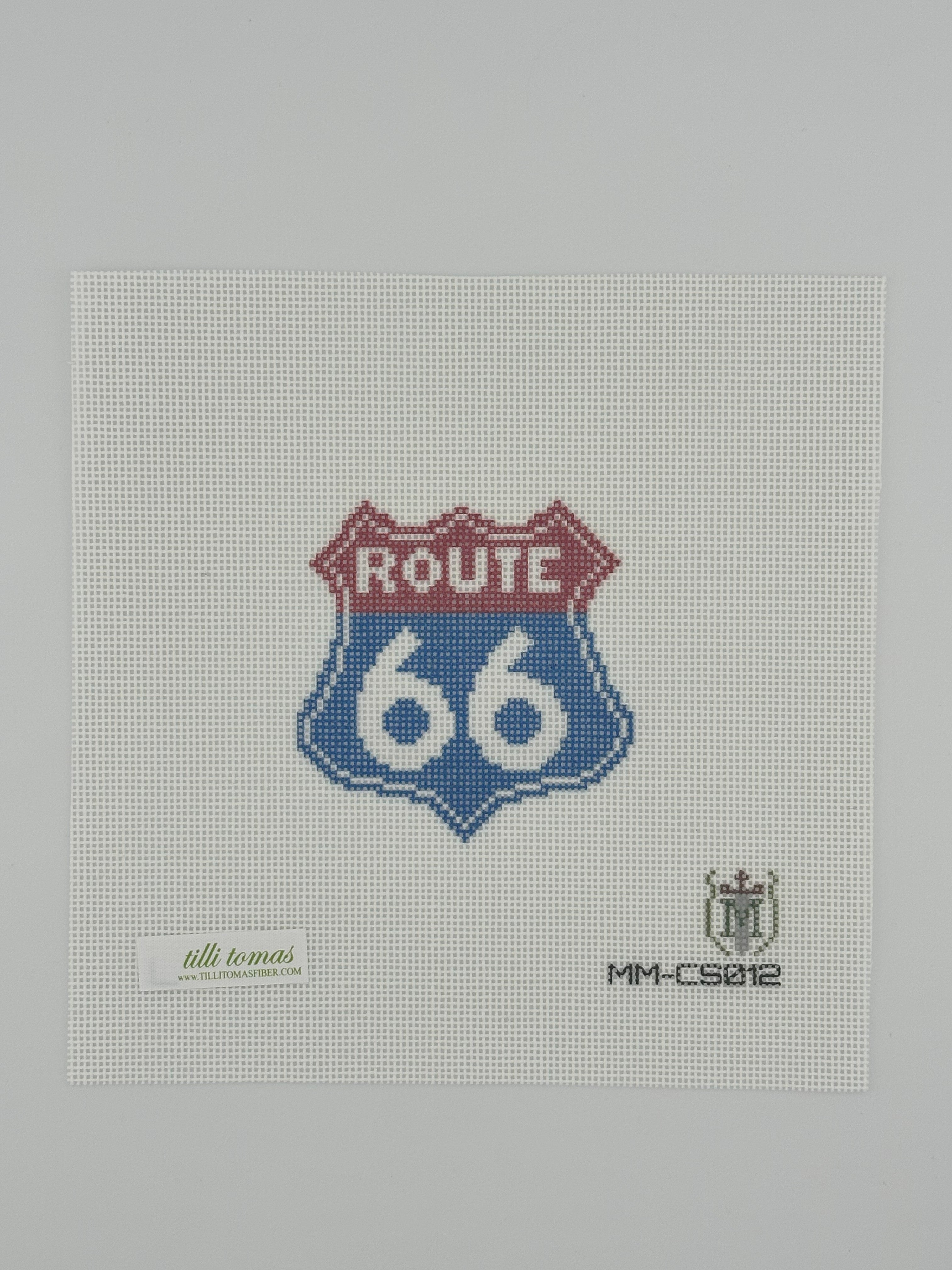 Route 66 needlepoint canvas by Misty Morrow on 18 mesh in red and blue 3" x 3" square lying flat on white background.