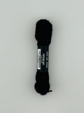 30 yard skein of Pepper Pot Silk needlepoint thread in pepper 001, with black and white label lying flat on white background