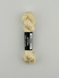 30 yard skein of Pepper Pot Silk needlepoint thread in vanilla 058, with black and white label lying flat on white background
