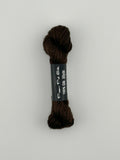 30 yard skein of Pepper Pot Silk needlepoint thread in chocolate 071 brown with black and white label lying flat on white background