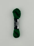 30 yard skein of Pepper Pot Silk needlepoint thread in peas 089, with black and white label lying flat on white background