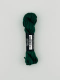 30 yard skein of Pepper Pot Silk needlepoint thread in pickle 090, with black and white label lying flat on white background