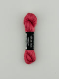 30 yard skein of Pepper Pot Silk needlepoint thread in quartz 134, with black and white label lying flat on white background
