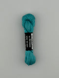 30 yard skein of Pepper Pot Silk needlepoint thread in robins egg 176, with black and white label lying flat on white background