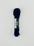 30 yard skein of Pepper Pot Silk needlepoint thread in magic 189, with black and white label lying flat on white background