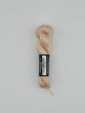 30 yard skein of Pepper Pot Silk needlepoint thread in powder puff 193 beige with black and white label lying flat on white background