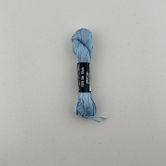 30 yard skein of Pepper Pot Silk needlepoint thread in drift 201, with black and white label lying flat on white background