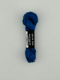 30 yard skein of Pepper Pot Silk needlepoint thread in yacht club 203, with black and white label lying flat on white background