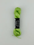30 yard skein of Pepper Pot Silk needlepoint thread in friscees 226, with black and white label lying flat on white background