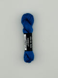 30 yard skein of Pepper Pot Silk needlepoint thread in oswego 227 with black and white label lying flat on white background