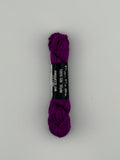 30 yard skein of Pepper Pot Silk needlepoint thread in piroutte 240, with black and white label lying flat on white background