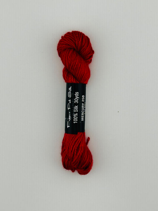 30 yard skein of Pepper Pot Silk needlepoint thread in mercury 250, with black and white label lying flat on white background