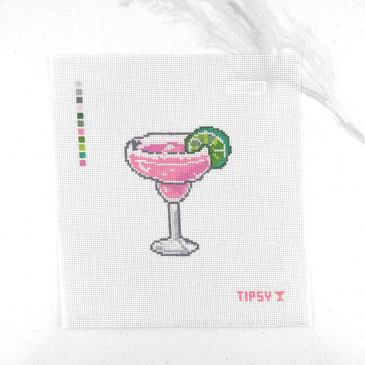 A square 18 mesh needlepoint canvas featuring a pink margarita cocktail in a glass with a lime wedge, on a white background with a small red TIPSY  text at the bottom right.