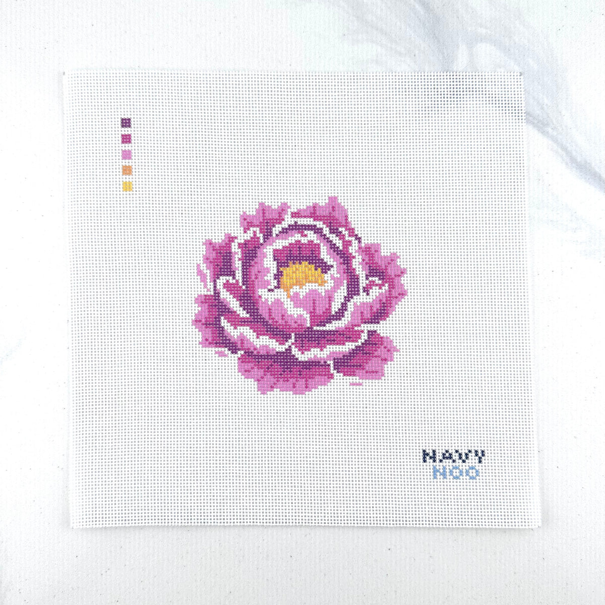 18 mesh needlepoint canvas featuring a pink peony flower with a yellow center, plus small color key squares on the left and the text 'NAVY NOO' on the bottom right, photographed on a white background.
