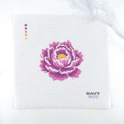 18 mesh needlepoint canvas featuring a pink peony flower with a yellow center, plus small color key squares on the left and the text 'NAVY NOO' on the bottom right, photographed on a white background.