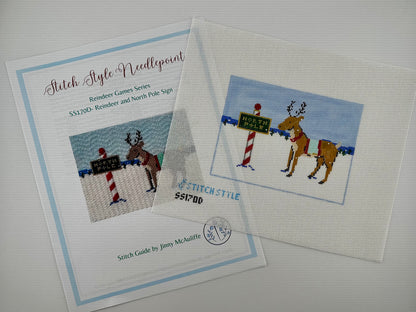 18 mesh needlepoint canvas featuring a Christmas scene with a brown reindeer wearing a red harness, standing next to a red-and-white striped pole with a green sign that reads 'NORTH POLE'. With the brand name 'STITCHSTYLE' and number 'S51700' printed in blue at the bottom left. Shown with stitch guide.