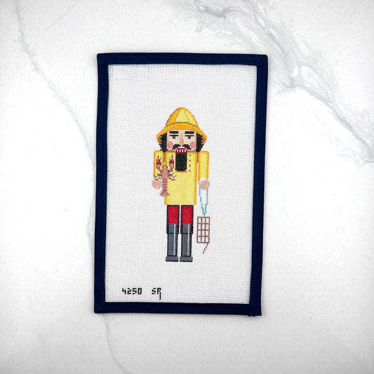 susan roberts yellow lobster catcher nutcracker canvas, 18 mesh, 6.5" high lying flat on white background