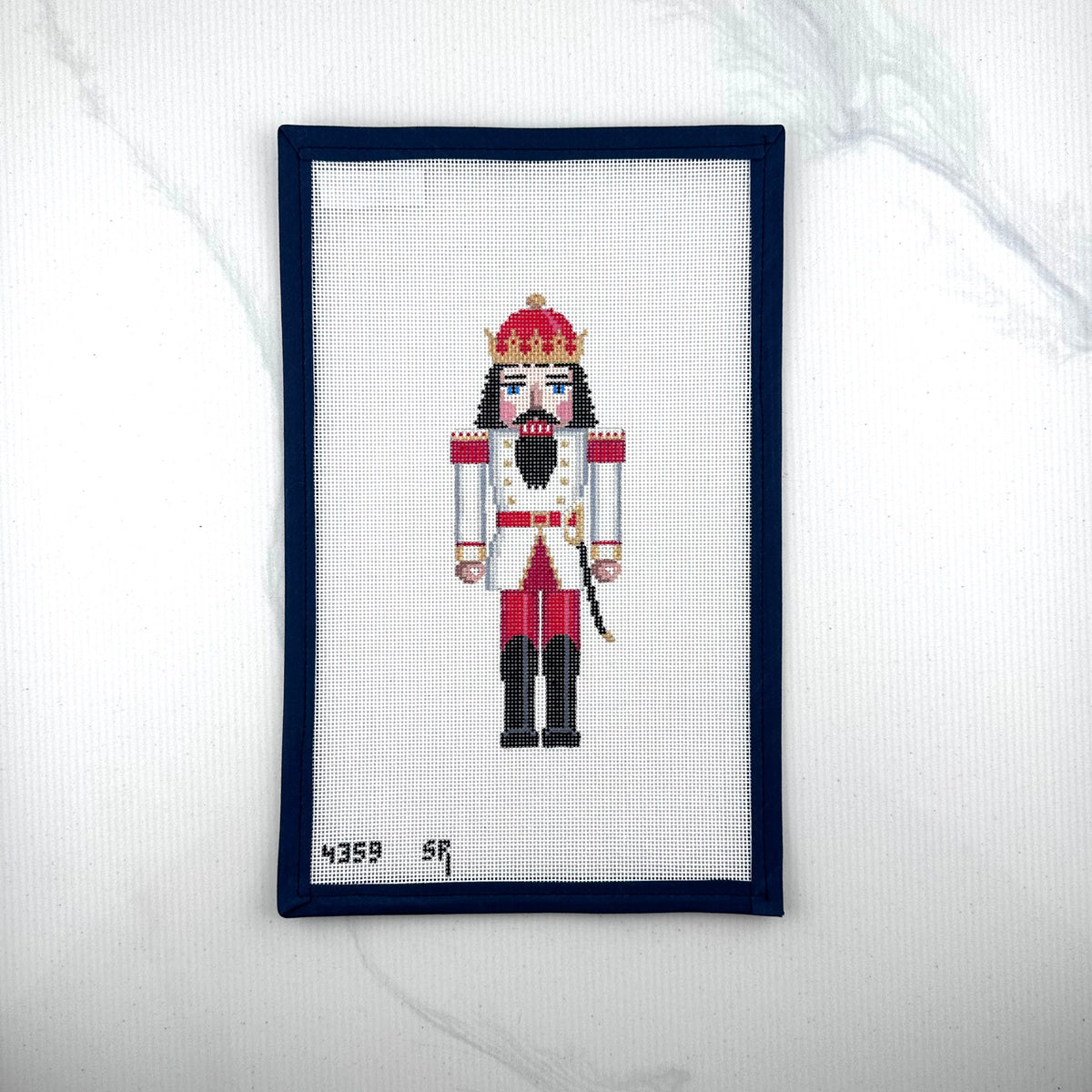 susan roberts white and red king nutcracker canvas, 18 mesh, 6.5" high lying flat on white background