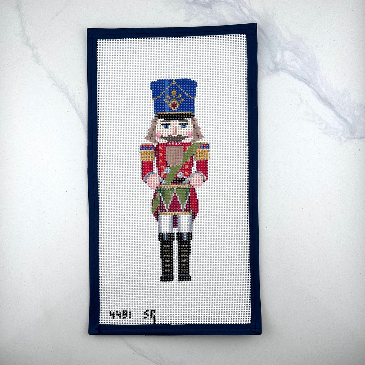 susan roberts drummer nutcracker canvas, 13 mesh, 9.5" high lying flat on white background