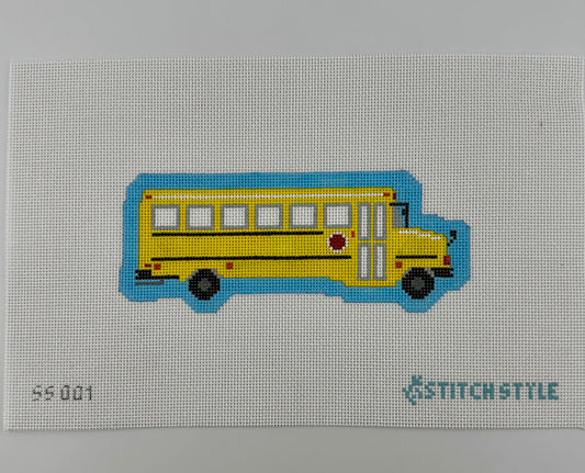 A 18 mesh needlepoint canvas featuring a yellow school bus with black wheels and a blue shadow, on a white background with the Stitchstyle logo in the bottom right corner.
