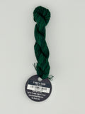 14 yard skein Planet Earth Silk 4 Ply needlepoint thread, in t-rex v 1335  green with round black and white label lying flat on white background.