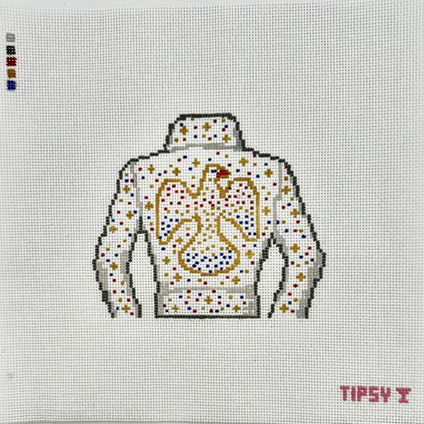 18  mesh The King needlepoint canvas featuring white elvis style jacket and with red, gold, silver and blue sparkle to look like rhinestones outlined with gold stitching on a white fabric background. The text 'TIPSY' appears in red at the bottom right.