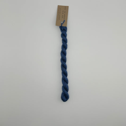 30 yard skein of silk & Ivory in the color 36 Admiral Blue with brown tag laying flat on white background