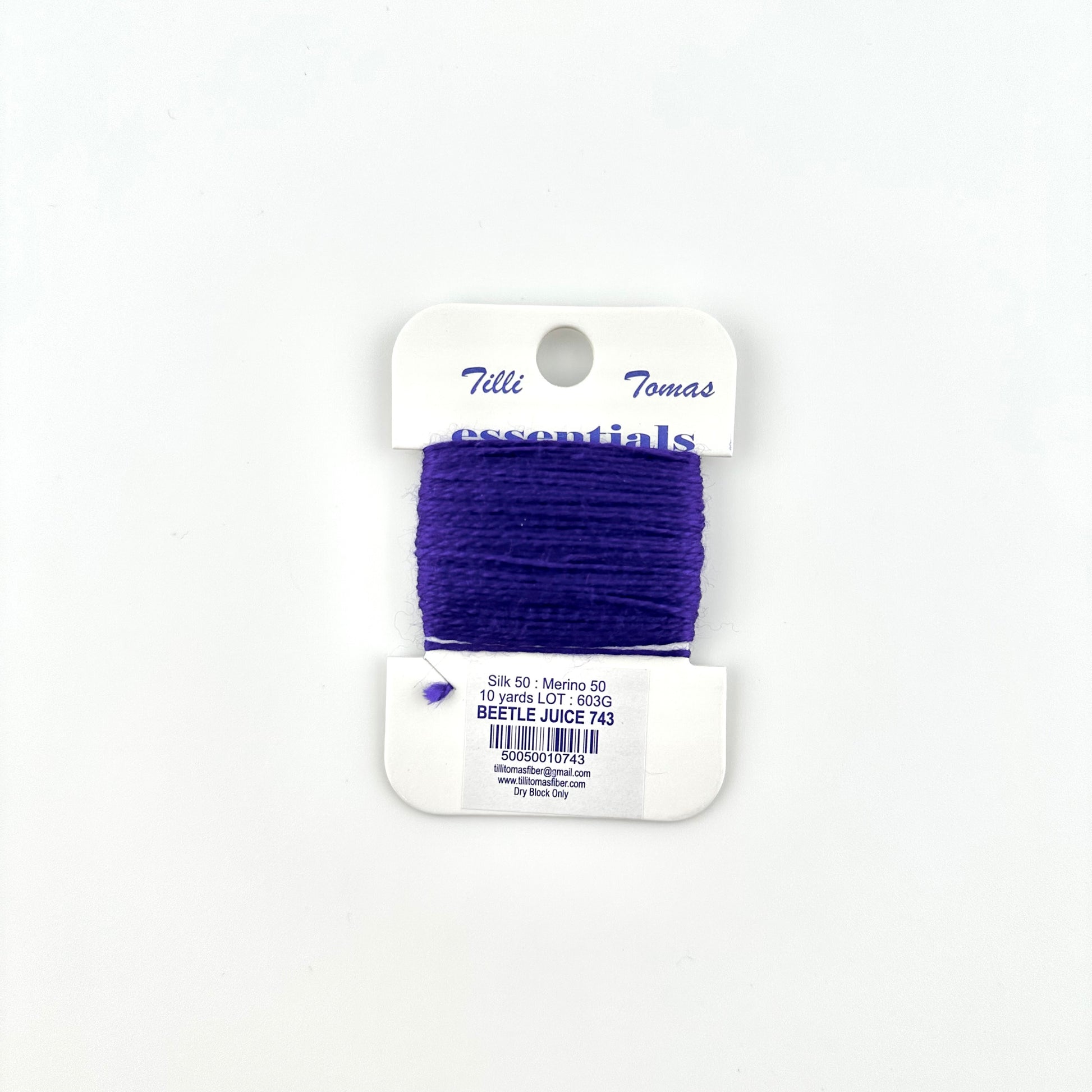 Tilli Tomas Essentials needlepoint thread, in purple color beetle juice 743.  50% silk, 50% merino wool, 10 yards wound on a white cardboard card.