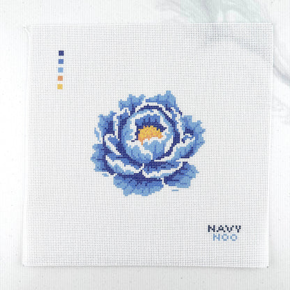 18 mesh needlepoint canvas featuring a blue peony flower with a yellow center, plus small color key squares on the left and the text 'NAVY NOO' on the bottom right, photographed on a white background.
