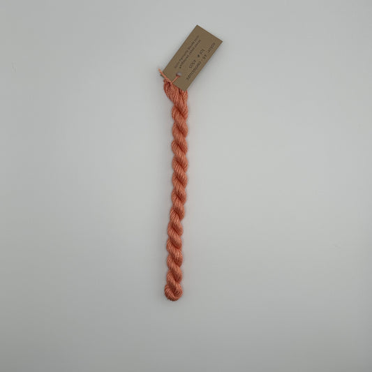 30 yard skein of silk & Ivory in the color 48 Cantaloupe with brown tag laying flat on white background