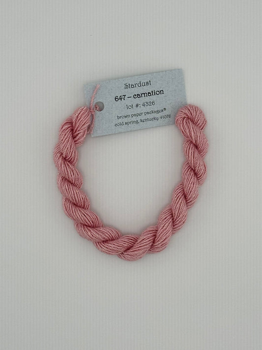 30 yard skein of Stardust Silk and Ivory needlepoint thread in Carnation 647, with light blue label lying flat on white background