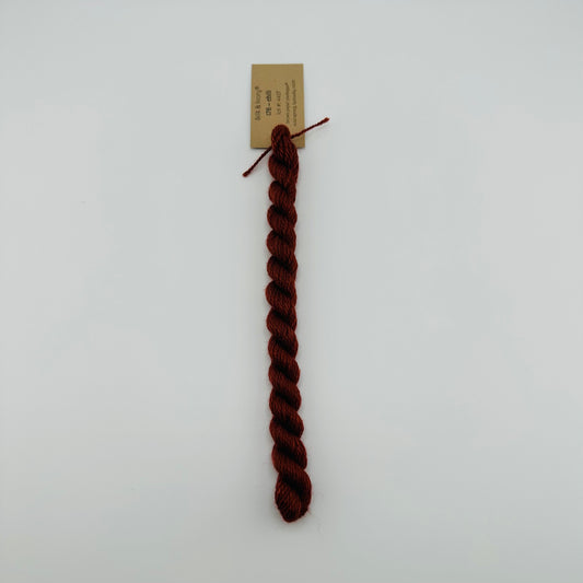 30 yard skein of silk & Ivory in the color 176 Chili with brown tag laying flat on white background